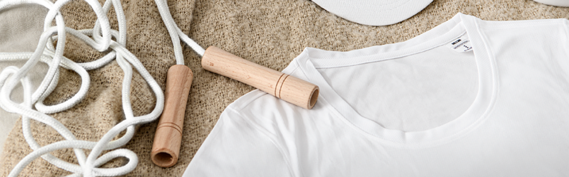 Camiseta blanca y cuerda para saltar en suéter beige.