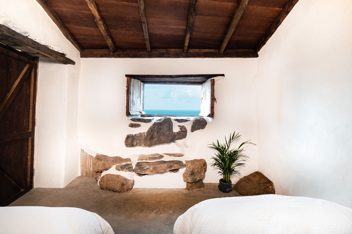 Habitación rústica con ventana al mar y planta en Casa en Tenerife.