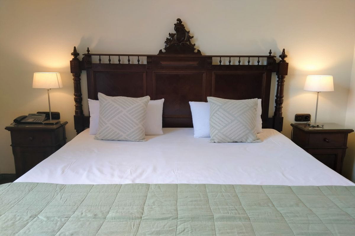 Cama doble con cabecero de madera en hotel de Tenerife.