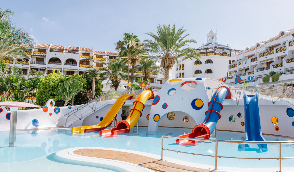 Toboganes de colores en piscina infantil de hotel en Tenerife.