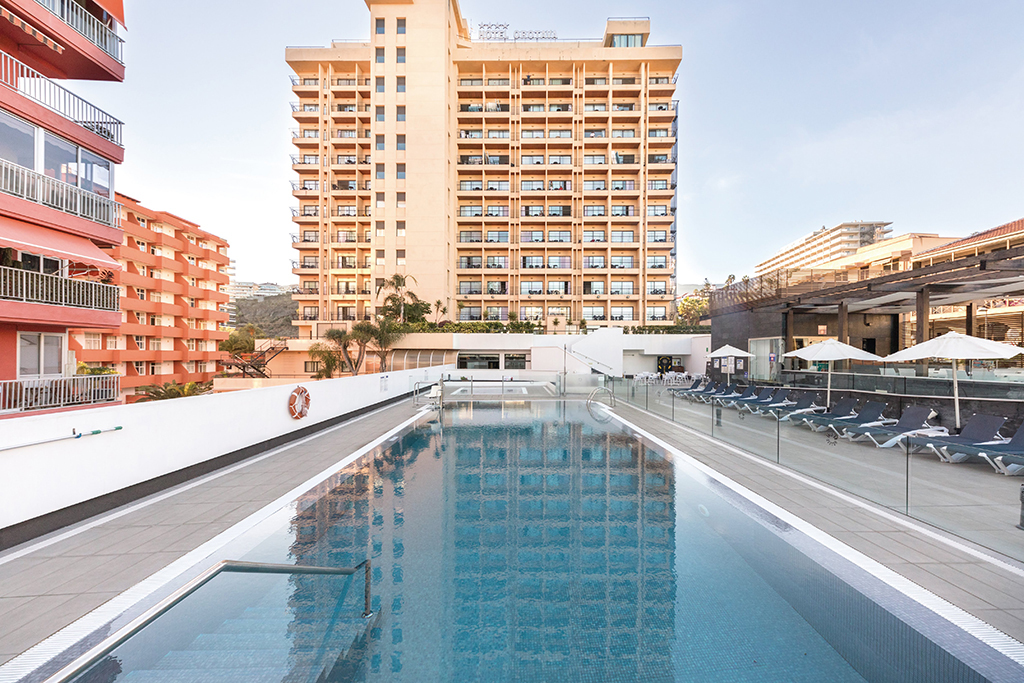 Piscina al aire libre frente a edificio en Puerto de la Cruz, Tenerife.