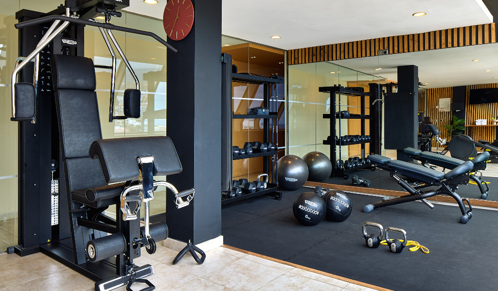 Gimnasio con equipamiento moderno y pesas en un hotel en Tenerife.