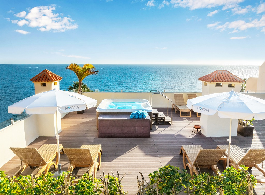 Terraza con jacuzzi, sombrillas y tumbonas frente al mar en Tenerife.