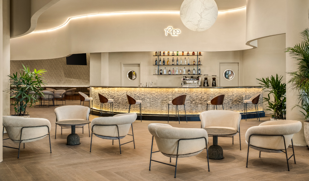 Bar contemporáneo con sillas y barra iluminada, interior en Tenerife.