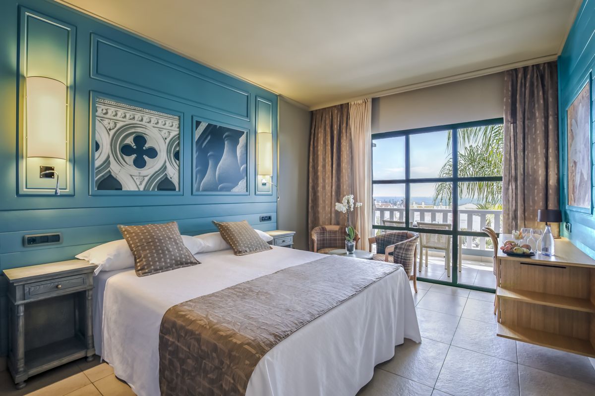 Habitación de hotel en Tenerife con vista hacia el mar desde el balcón.