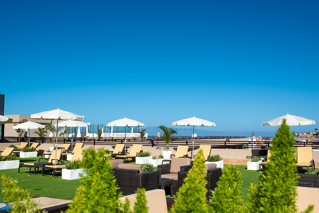 Terraza con tumbonas y sombrillas en un hotel de Tenerife.
