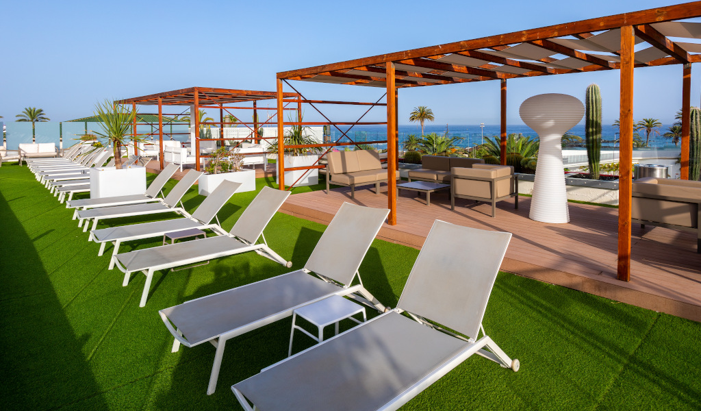 Tumbonas y terraza con vista al mar en un hotel en Tenerife.
