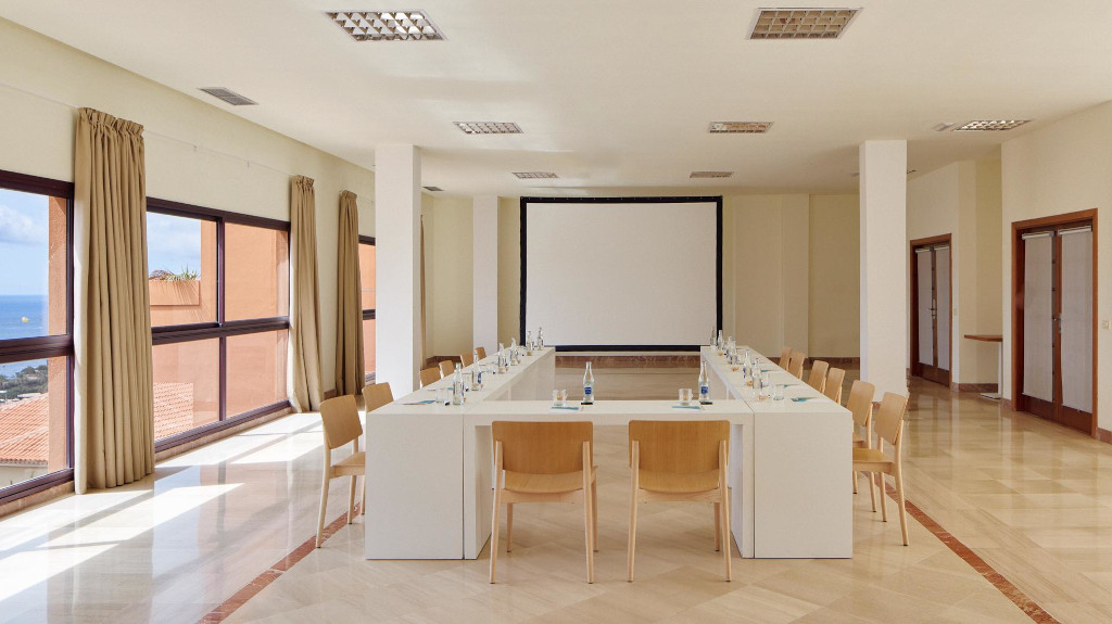 Sala de reuniones con pantalla y ventanas al mar en Tenerife.