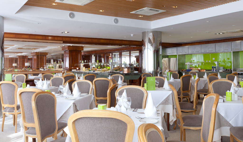 Restaurante con mesas preparadas y sillas en hotel de Tenerife.