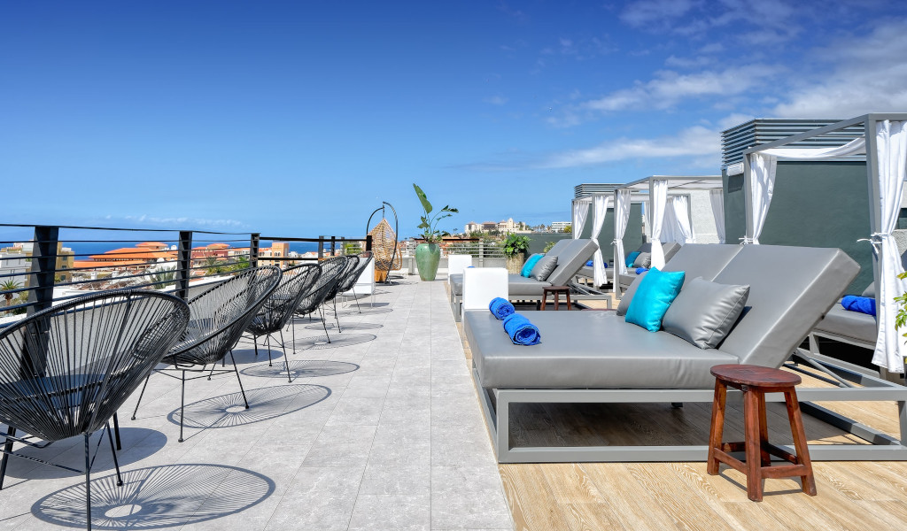 Terraza con tumbonas y vistas al mar en hotel de Tenerife.