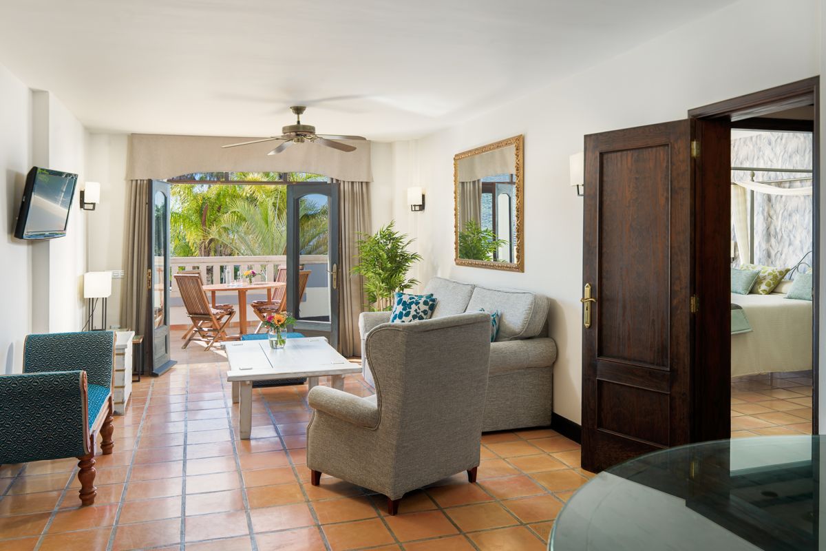 Sala de estar con balcón y muebles, en un apartamento en Tenerife.