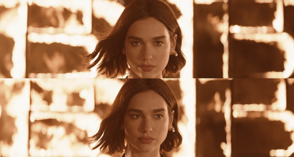 Primer plano de una mujer con pelo corto frente a un fondo iluminado por llamas, en tono cinematográfico.
