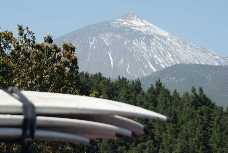 Tablas de surf apiladas con el Teide de fondo en Tenerife.