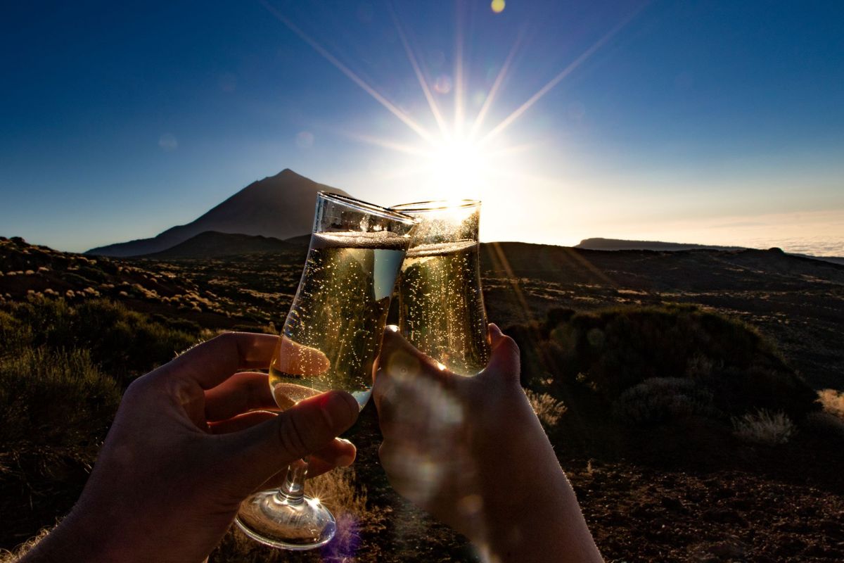 Brindis con copas de champagne al atardecer cerca del Teide, Tenerife.
