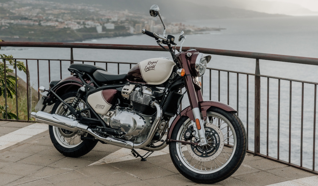 Motocicleta Royal Enfield estacionada con vista al mar en Tenerife.