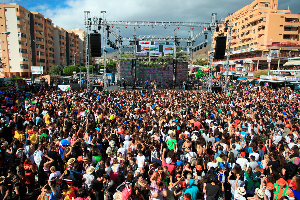 Concierto al aire libre en Tenerife con multitud de personas frente al escenario.
