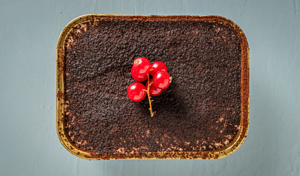 Postre de chocolate con grosellas rojas sobre la mesa en Tenerife.
