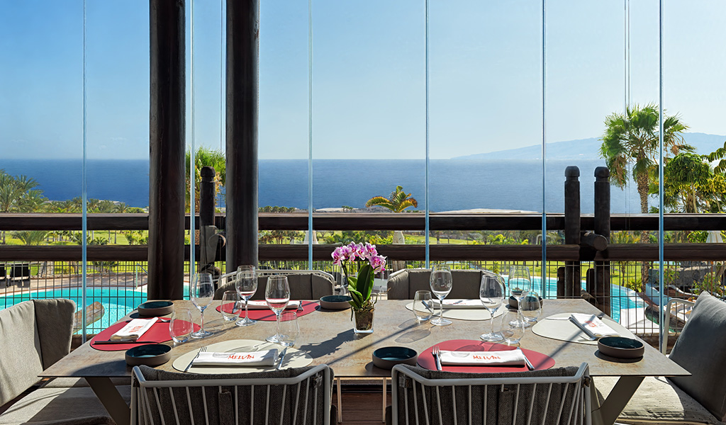 Mesa con vajilla en restaurante con vista al mar en Tenerife.