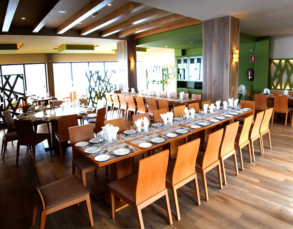 Comedor elegante con mesas y sillas de madera preparadas en Tenerife.