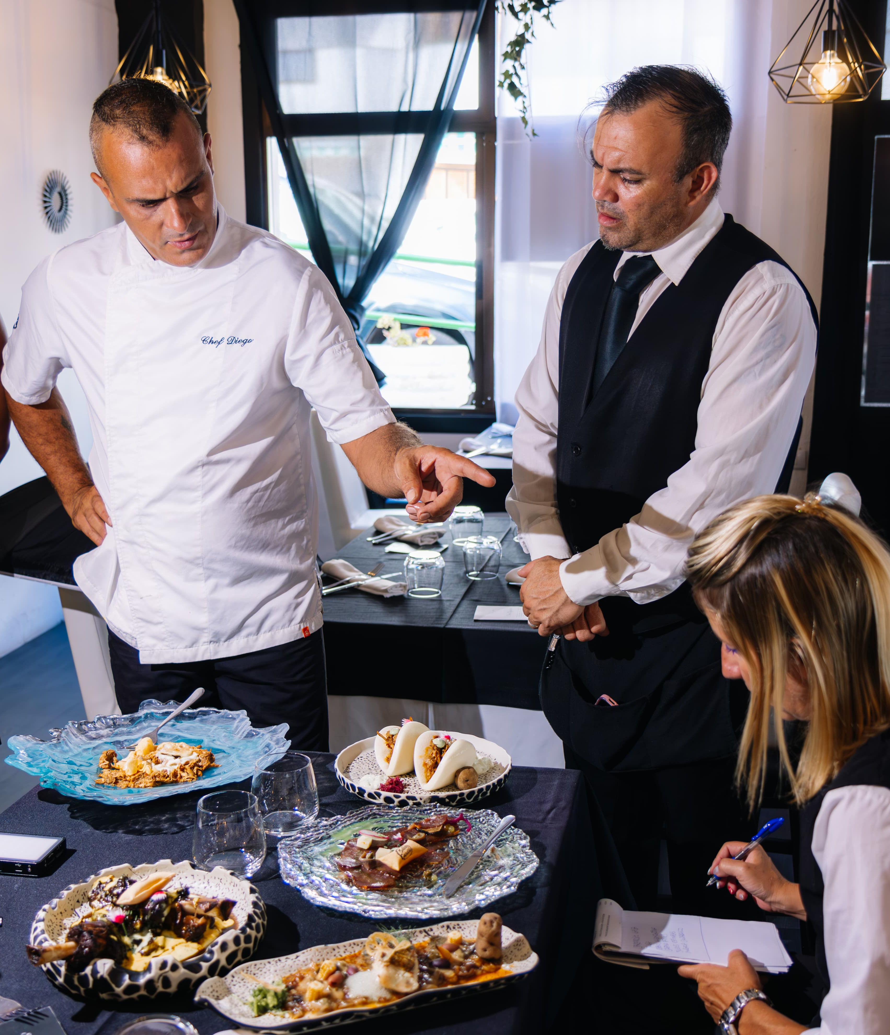 Chef y equipo revisan platos gourmet en Puerto de la Cruz, Tenerife.