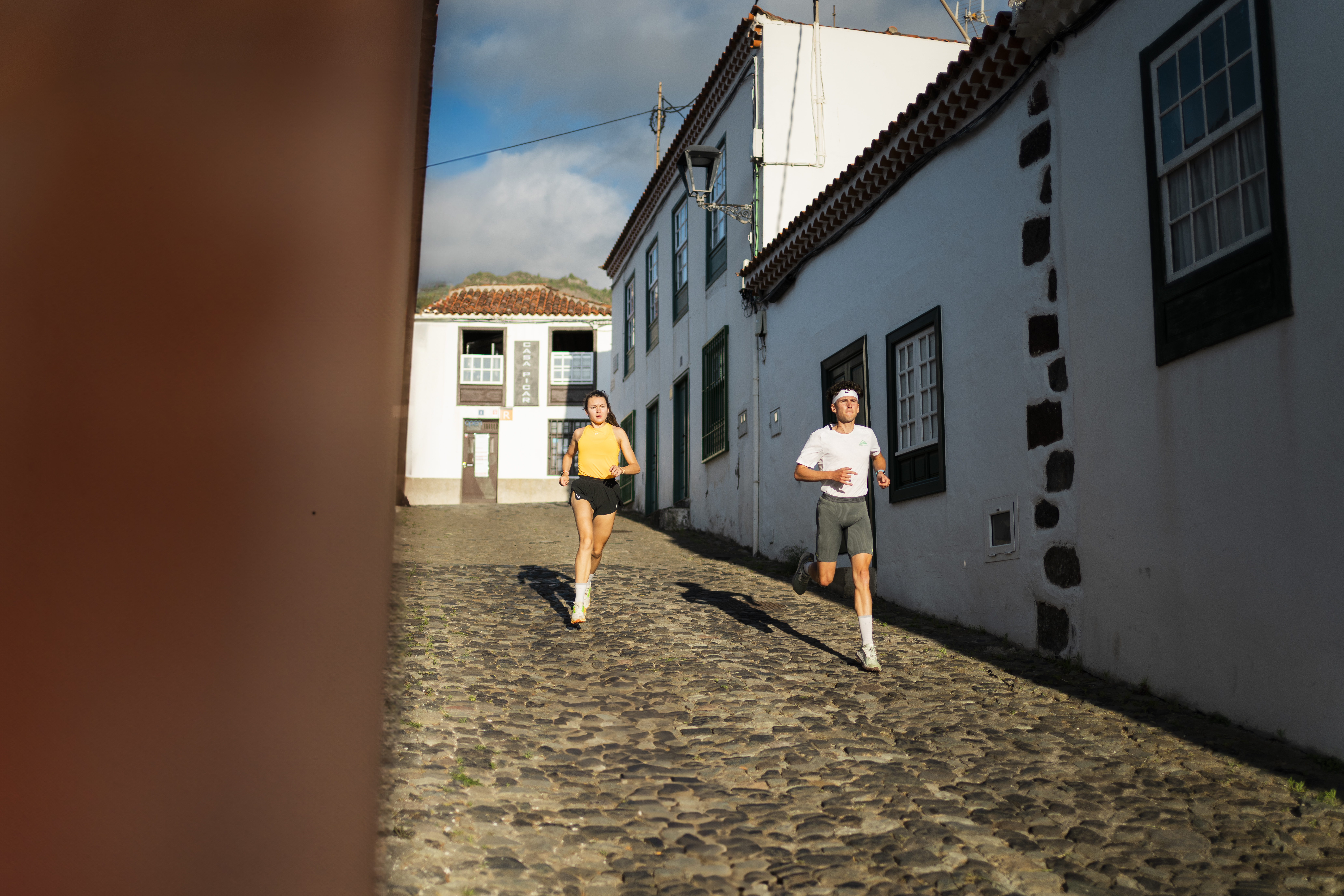 Personas corriendo en una calle adoquinada en Tenerife.