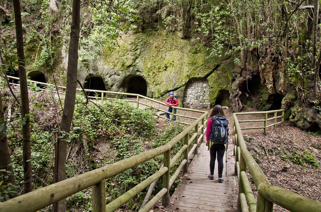 Sendero con personas y cuevas en Anaga, Tenerife.