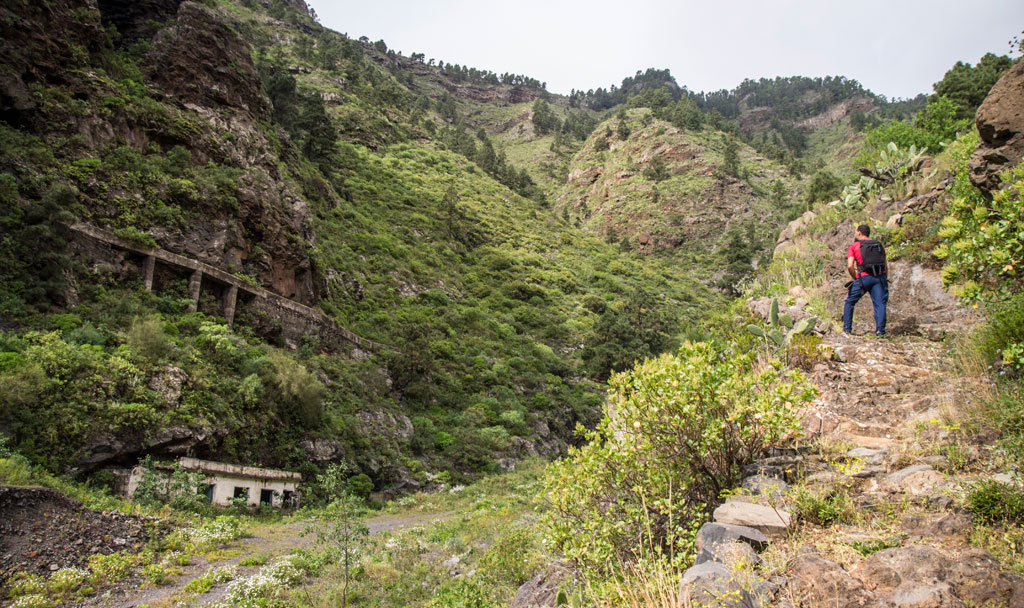 Sendero de montaña con excursionista en el Barranco de Masca, Tenerife.