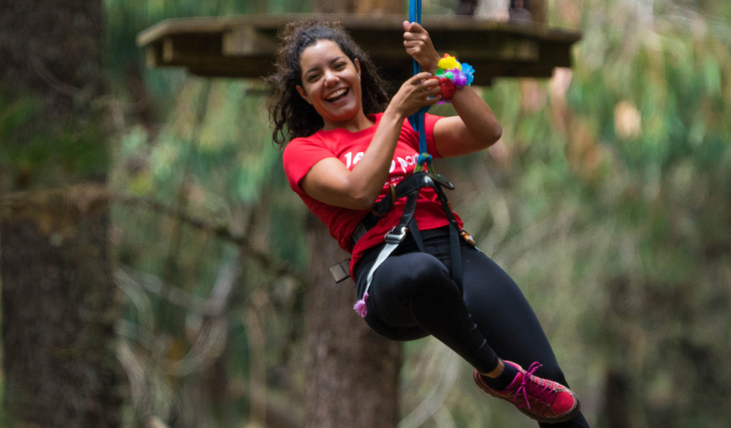Persona disfrutando de un paseo en tirolina en un bosque de Tenerife.