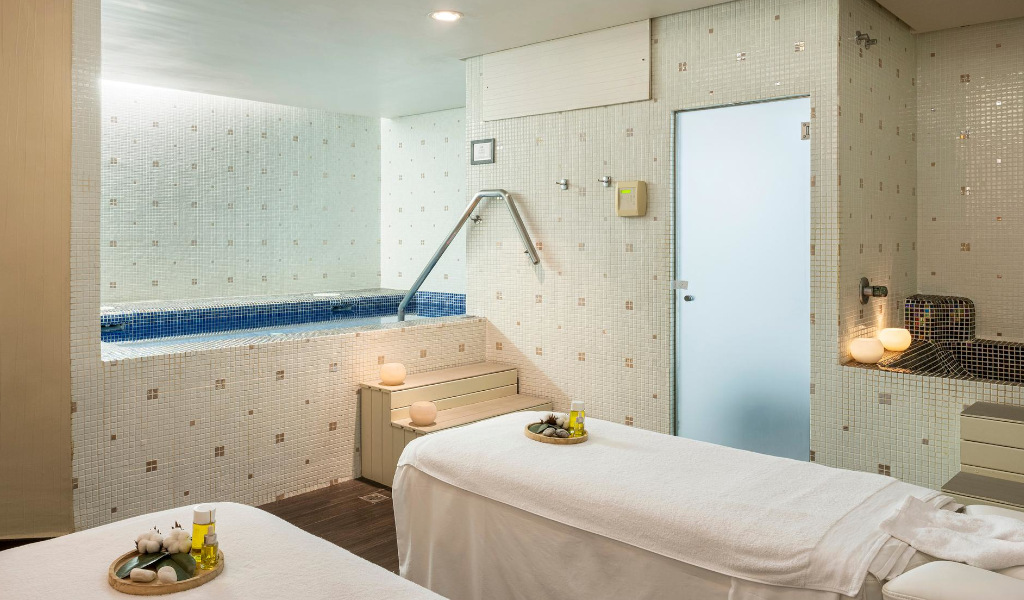 Sala de tratamiento de spa con piscina y camillas en Tenerife.