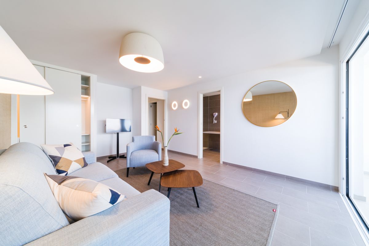 Sala moderna con sofá, silla, mesa de centro y televisor, Tenerife.